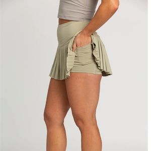 Pale Moss Pleated Tennis Skirt from GOLDHINGE workout skirt, tennis skirt